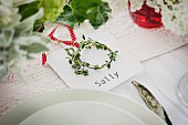 Place setting with name card and little wreath of herbs