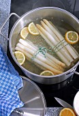 Asparagus with lemon being cooked in a pot