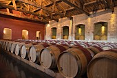 Wooden barrels and amphorae in the cellar at Chateau Pontet-Canet (Bordeaux, France)