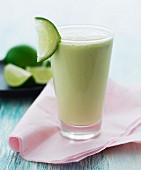 A smoothie garnished with a lime wedge