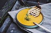 Cream of pumpkin soup with pears and rosemary