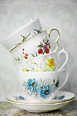 A stack of vintage, floral-patterned cups