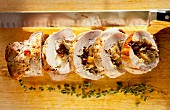 Sliced pork loin roulade filled with apples and figs