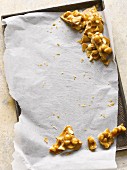 Peanut brittle on a baking tray
