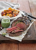 Roast beef with herb sauce and oven-roasted vegetables