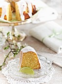 A slice of almond and lime cake on a glass plate