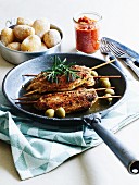 Turkey escalopes with an olive marinade on skewers served with salted potatoes and mojo sauce