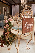 Vintage chair made from rusty, curved metal decorated for wedding