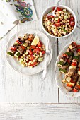Pork loin and vegetable skewers with a chickpea, cucumber and tomato salad