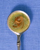 Potato soup with wild garlic on a ladle