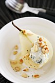 A poached pear with Gorgonzola cream, pine nuts and honey