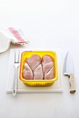 Fresh chicken breasts in an open plastic packet