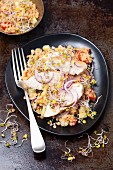 A salad with lentils, cucumber, tomato, radish and and grilled chicken breast