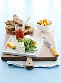 A cheese platter with chutney and nut bread