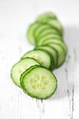 Cucumber slices on a white wooden surface