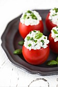 Tomatoes stuffed with cottage cheese, fresh chives and basil