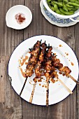 Chicken satay with spicy sauce and soja beans
