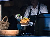 Street food – a vendors handing over a bowl of nachos