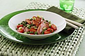 Sweet-and-sour pork loin with peas and tomatoes