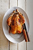 Roast chicken with carving cutlery