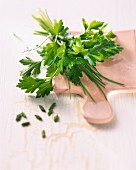 Parsley and chives on a chopping board