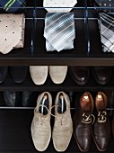 A wardrobe with compartments for shoes and accessories such as ties