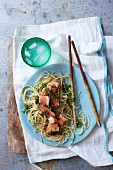 Salmon with a matcha tea, ginger and sesame seed crust on noodles (Asia)