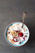 Yoghurt muesli with raspberries in a bowl with a spoon