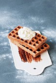 Chocolate waffles with a dollop of cream