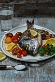 Roasted sea bream with grilled tomatoes, lemon, parsley, sea salt and rosemary