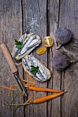 Sardines on bread, figs, sea salt, parsley, yellow tomatoes and carrots