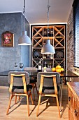 Retro dining area in front of wine rack in niche