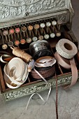 Vintage cash register used to store sewing utensils