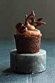 A chocolate cupcake with cherries