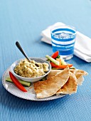 Hummus with lemon and coriander served with unleavened bread and vegetable sticks