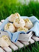 Meringue with pistachios in a basket for a picnic