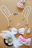 Hand-drawn rabbit decorated with fabric bow, quails' eggs & feathers