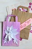 Creative crafting with paper: paper bags with glued and stamped decorations