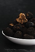Black truffles on a white plate