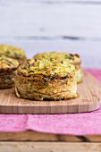 Cauliflower and courgette cakes on a wooden board