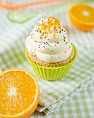 An orange and poppy seed cupcake