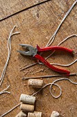 A pair of pliers, corks and thread