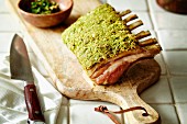 Rack of Lamb with Herb Crust on Cutting Board; Sliced