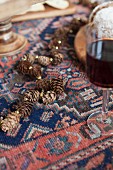 Garland of larch cones and gold beads on Oriental rug