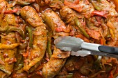 Baked sausages with peppers and onions (full frame)