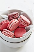 Pink macaroons in a porcelain bowl