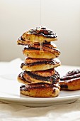 Honey dripping down a stack of sticky buns