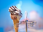 A cone of soft-serve ice cream in a cone holder