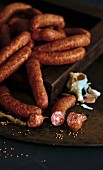 Sausages with garlic on a wooden plate