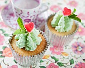 Cupcakes with mint icing and heart-shaped sweets
